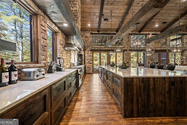 bar featuring wood ceiling, a healthy amount of sunlight, a notable chandelier, and hardwood / wood-style flooring