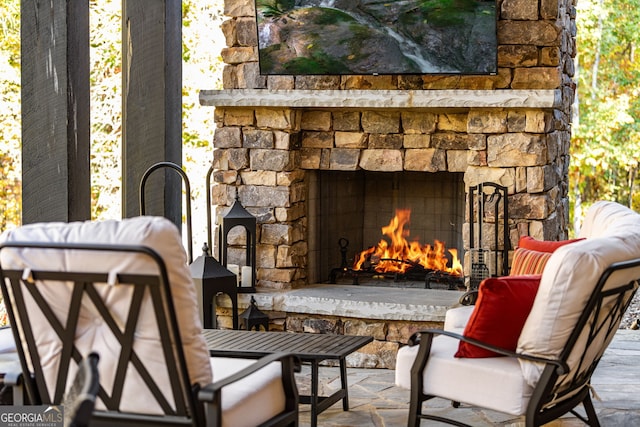 living area featuring an outdoor stone fireplace