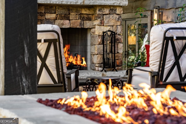 details with an outdoor stone fireplace and an outdoor fire pit