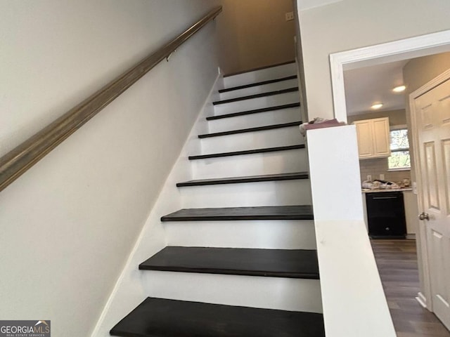 staircase with wood-type flooring