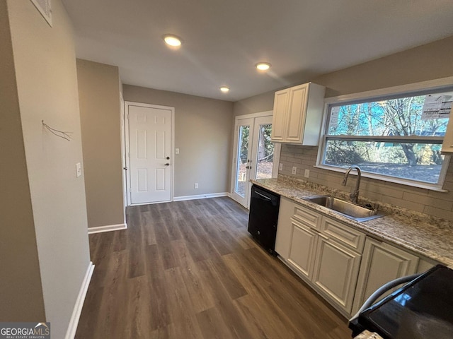 kitchen with light stone countertops, tasteful backsplash, dark wood-type flooring, sink, and dishwasher