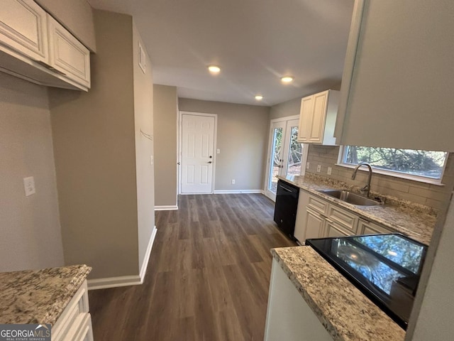 kitchen featuring sink, dishwasher, light stone counters, dark hardwood / wood-style flooring, and decorative backsplash