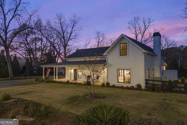 view of front of house featuring a porch and a yard