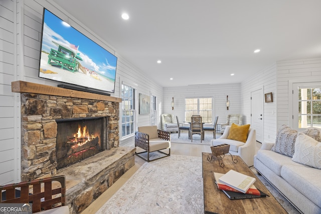 living room featuring hardwood / wood-style flooring and a stone fireplace