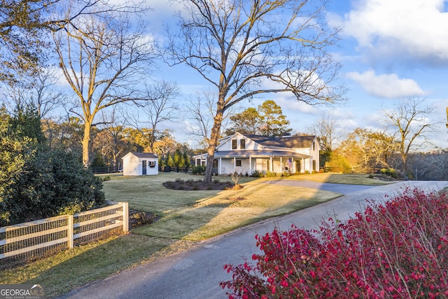 view of front of property featuring a front yard and a storage unit