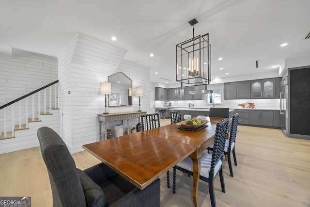 dining room featuring light wood-type flooring and a chandelier