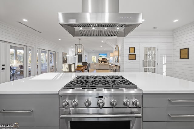 kitchen featuring gray cabinetry, a notable chandelier, high end stainless steel range oven, and range hood