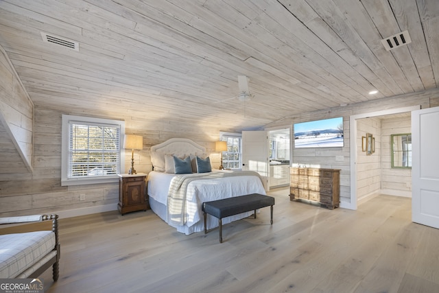 bedroom featuring wooden walls, wooden ceiling, lofted ceiling, and light wood-type flooring