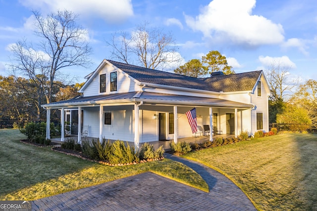 view of front of house with a porch and a front lawn