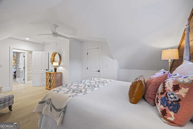 bedroom featuring ceiling fan, vaulted ceiling, and light wood-type flooring