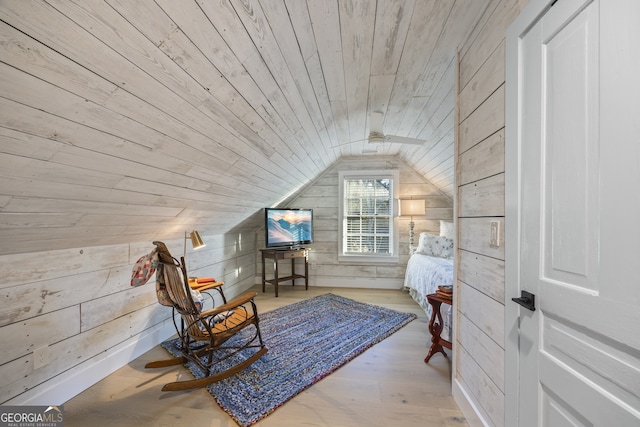 sitting room with wood ceiling, light wood-type flooring, lofted ceiling, and wooden walls