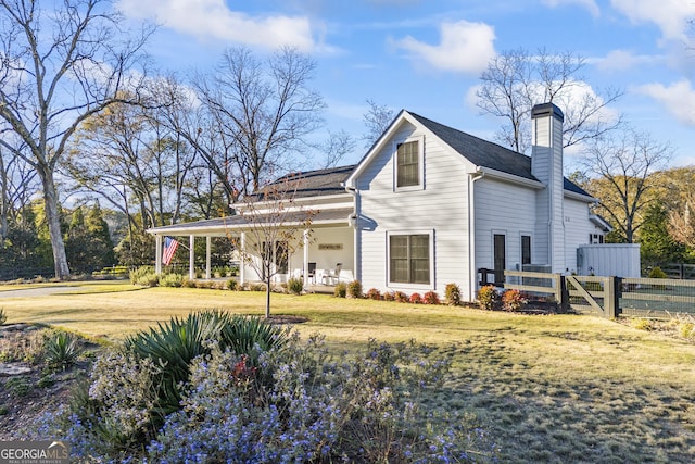 rear view of property featuring a yard