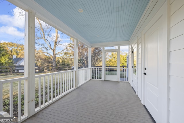 wooden terrace featuring covered porch