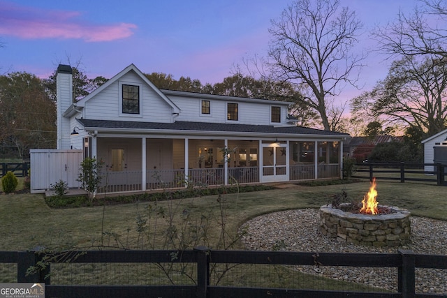 view of front of home featuring a yard and an outdoor fire pit