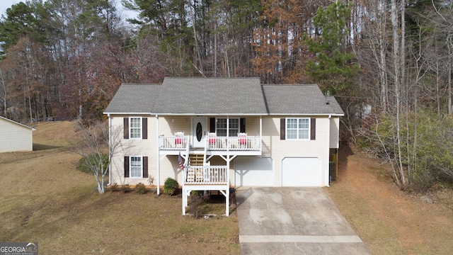 view of front of house featuring driveway, a garage, a porch, roof with shingles, and a front lawn