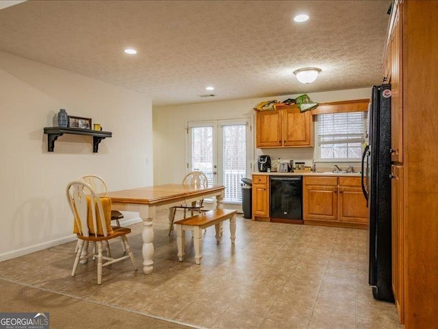 kitchen with french doors, sink, wine cooler, a textured ceiling, and black refrigerator