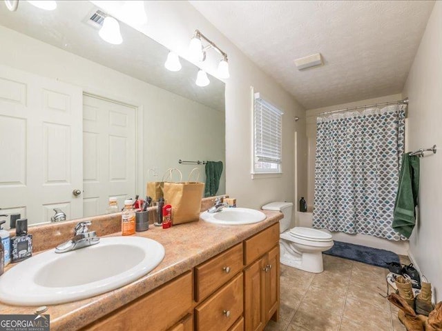 full bathroom featuring shower / tub combo, tile patterned floors, vanity, a textured ceiling, and toilet