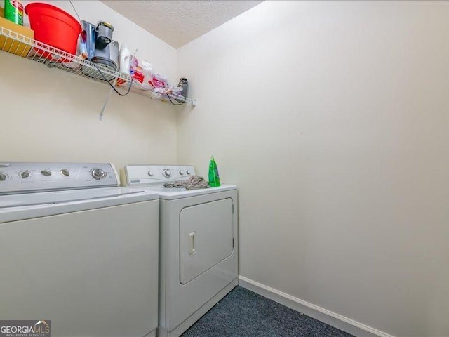 laundry room with washer and dryer and a textured ceiling