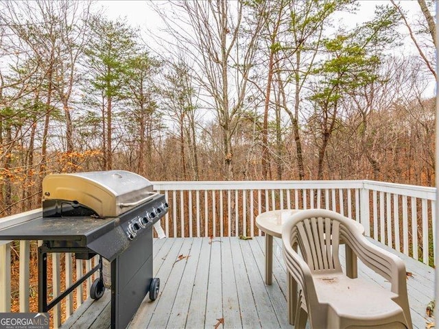 wooden terrace with a grill