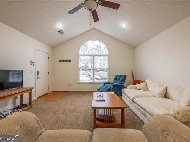 carpeted living room with ceiling fan and lofted ceiling