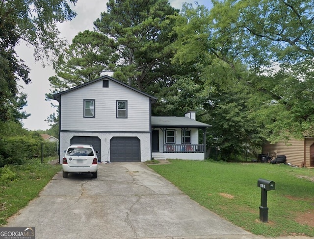 tri-level home featuring a front yard, a porch, and a garage