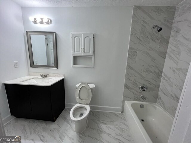 full bathroom featuring a textured ceiling, vanity, toilet, and tiled shower / bath