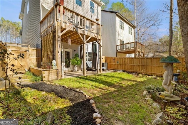 back of house with a wooden deck and a yard