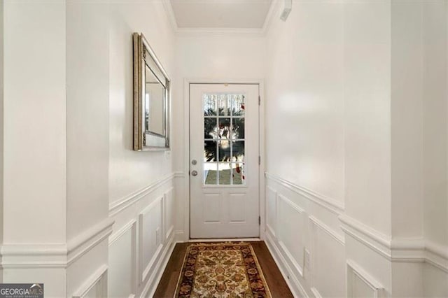 doorway with ornamental molding and dark hardwood / wood-style floors