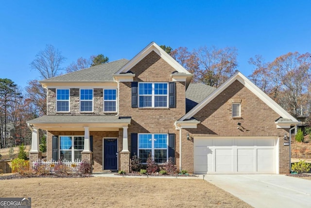 view of front of home with covered porch and a garage