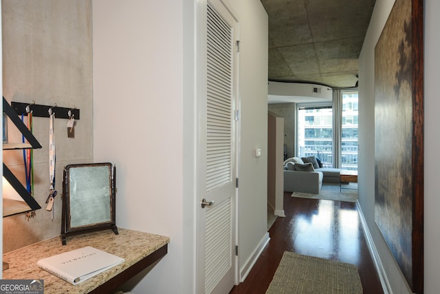 corridor with dark hardwood / wood-style flooring