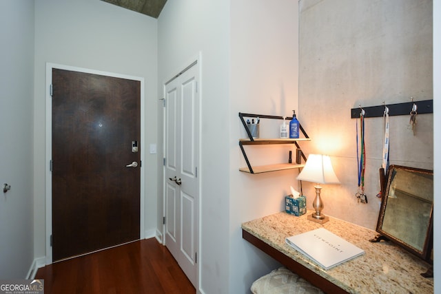 entryway with dark hardwood / wood-style flooring