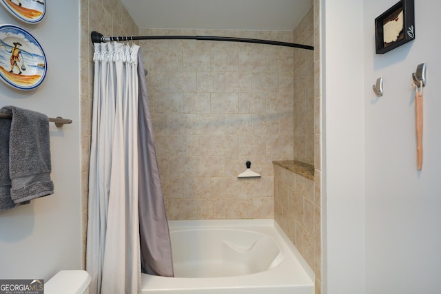 bathroom with toilet and shower / tub combo