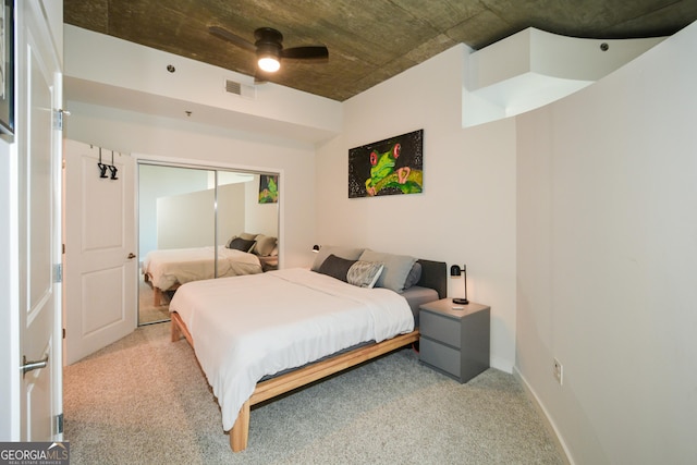 bedroom featuring ceiling fan, a closet, and light carpet