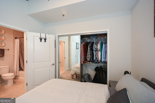 bedroom with ensuite bath and a closet