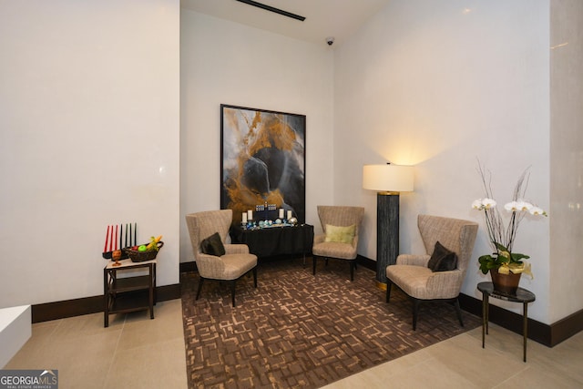 sitting room with vaulted ceiling and parquet flooring