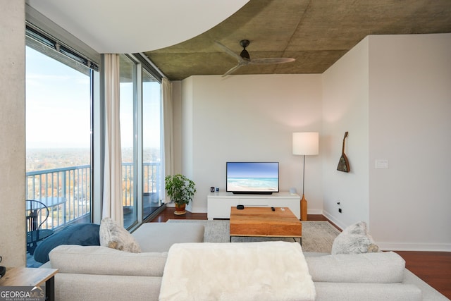 living room featuring ceiling fan and hardwood / wood-style flooring