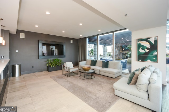 living room with a wall of windows and a fireplace