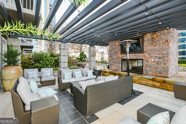 view of patio with an outdoor living space with a fireplace