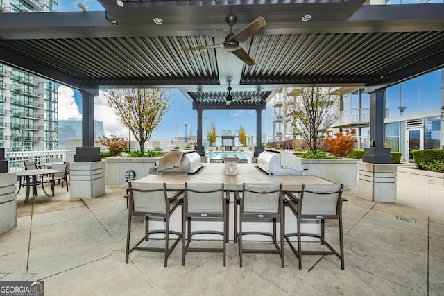 view of patio featuring ceiling fan, a grill, and an outdoor kitchen