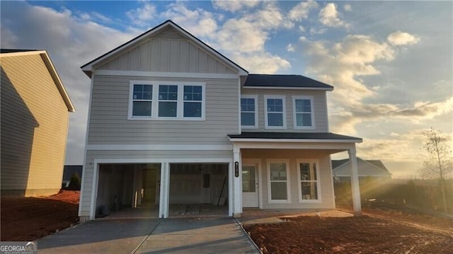 view of front facade featuring a porch and a garage