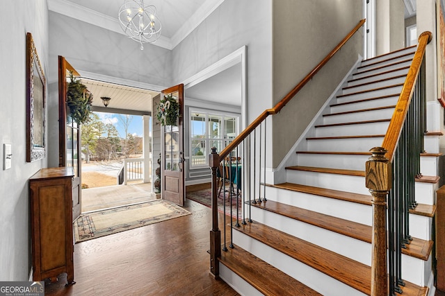 entrance foyer with a chandelier, dark hardwood / wood-style floors, and crown molding