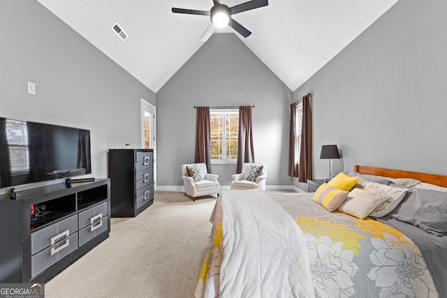 carpeted bedroom with ceiling fan and high vaulted ceiling