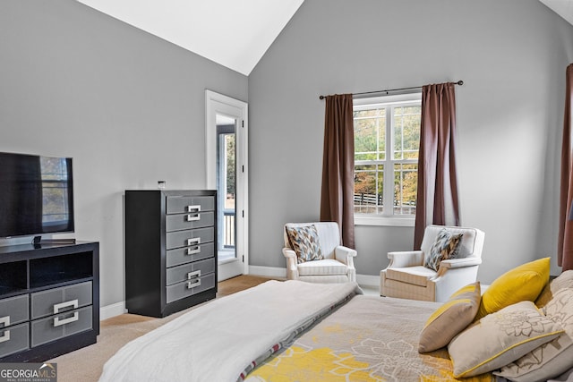 carpeted bedroom with high vaulted ceiling