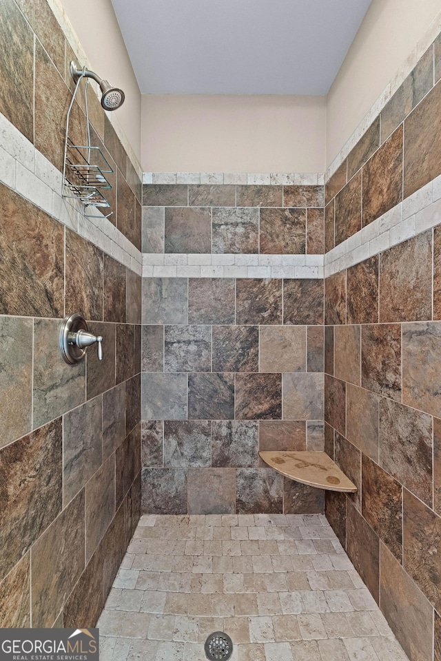 bathroom with a tile shower