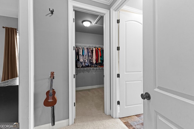 hallway with light carpet and crown molding