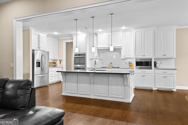 kitchen featuring dark hardwood / wood-style floors, white cabinetry, hanging light fixtures, and appliances with stainless steel finishes