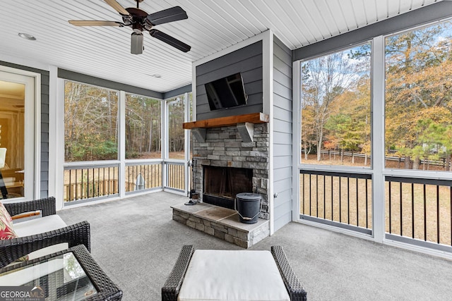 sunroom featuring a wealth of natural light, ceiling fan, and wooden ceiling