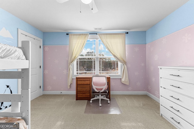 carpeted home office featuring ceiling fan