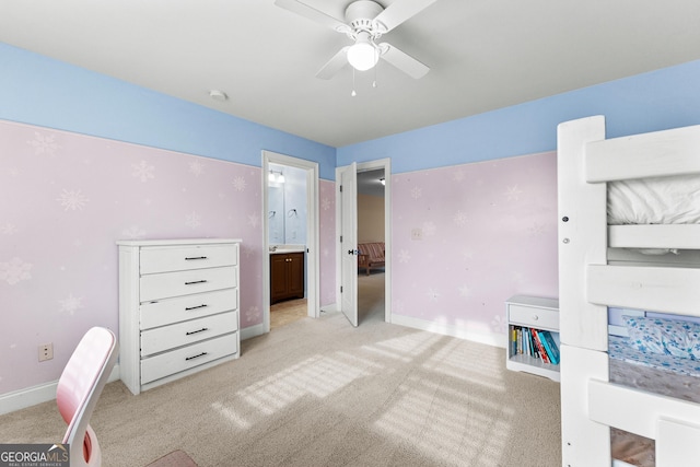 unfurnished bedroom with ceiling fan, ensuite bathroom, and light colored carpet