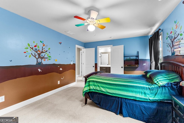 bedroom with ceiling fan, light colored carpet, and connected bathroom